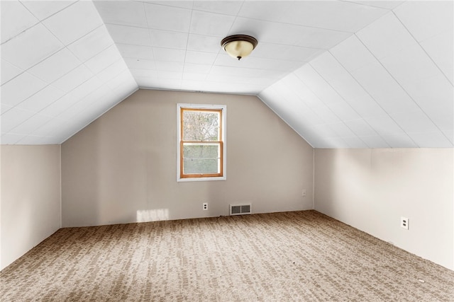 additional living space featuring carpet floors and vaulted ceiling