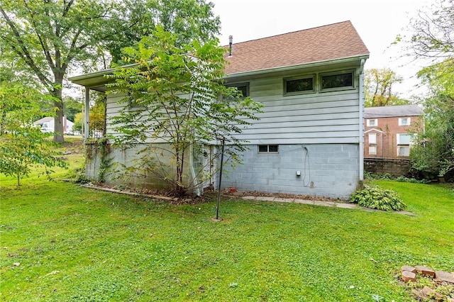 rear view of property featuring a yard