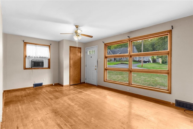 entrance foyer with ceiling fan, cooling unit, and light hardwood / wood-style flooring