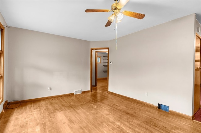 empty room with ceiling fan and wood-type flooring