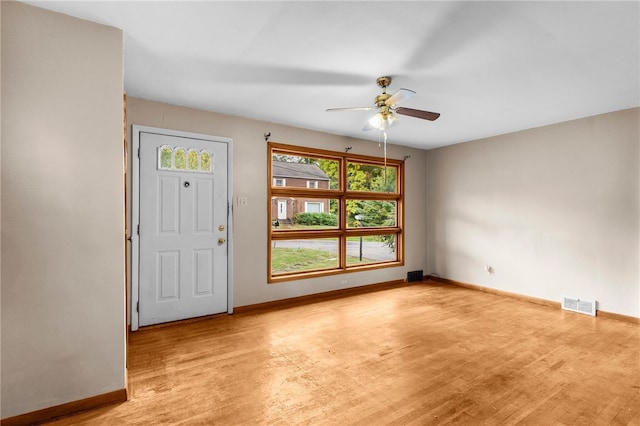 foyer with ceiling fan and light hardwood / wood-style flooring