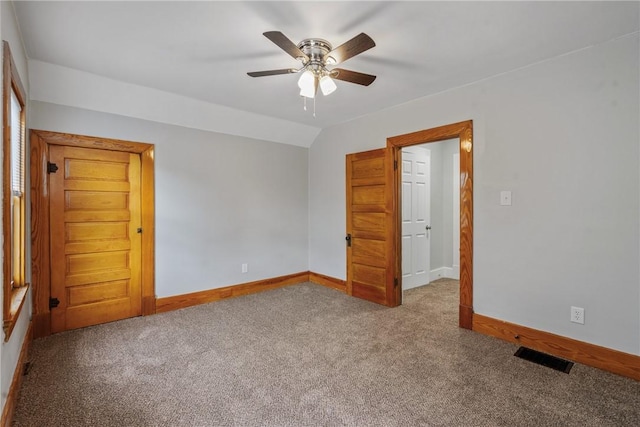 unfurnished bedroom with light carpet, vaulted ceiling, and ceiling fan