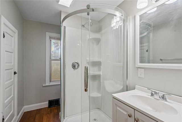 bathroom featuring a shower with door, vanity, and hardwood / wood-style floors