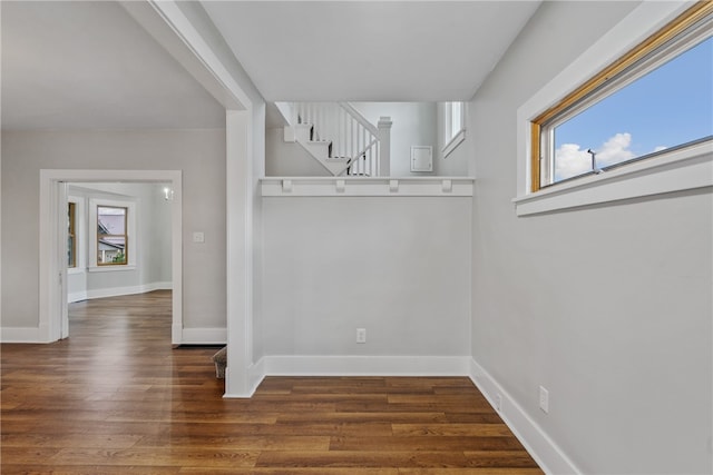 unfurnished dining area featuring dark hardwood / wood-style flooring