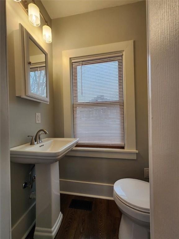 bathroom featuring sink, hardwood / wood-style floors, and toilet