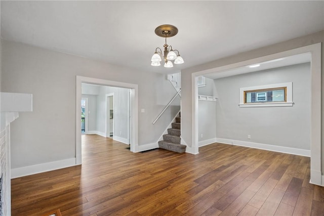 interior space with a chandelier and dark hardwood / wood-style flooring