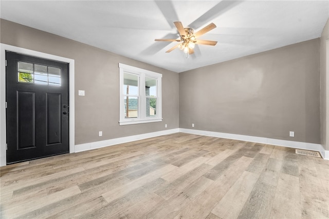 foyer featuring ceiling fan, light hardwood / wood-style flooring, and a healthy amount of sunlight