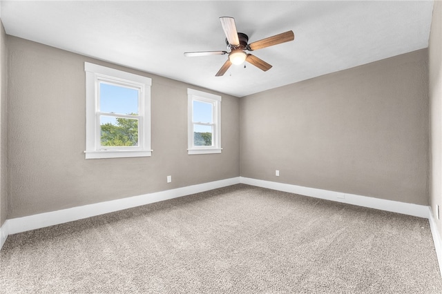 carpeted spare room with ceiling fan