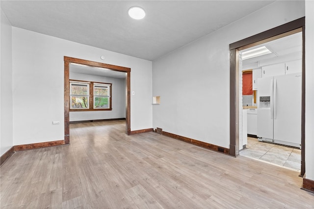 spare room with light wood-type flooring