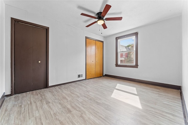 unfurnished bedroom with a closet, ceiling fan, and light wood-type flooring