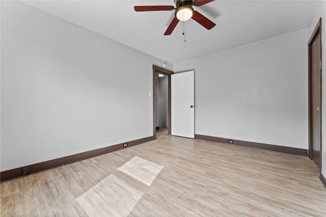 empty room with ceiling fan and light hardwood / wood-style floors