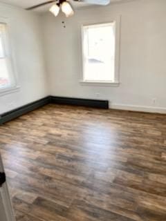 spare room featuring dark wood-type flooring and ceiling fan