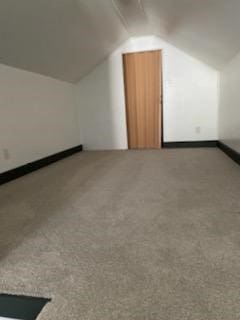 bonus room featuring carpet and vaulted ceiling