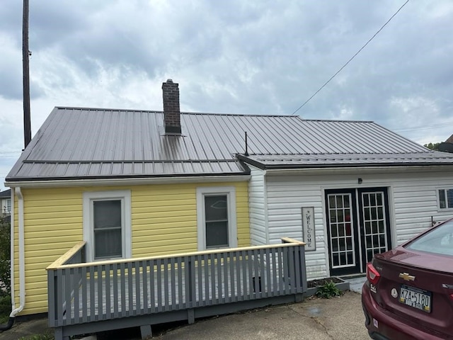 back of house featuring a wooden deck