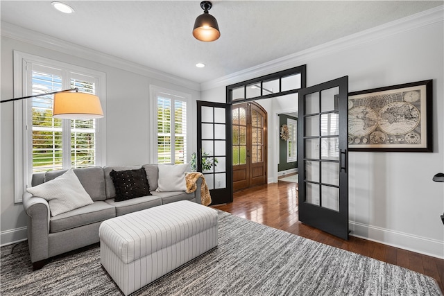 living room with crown molding, dark wood-type flooring, and french doors