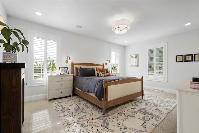 carpeted bedroom with multiple windows