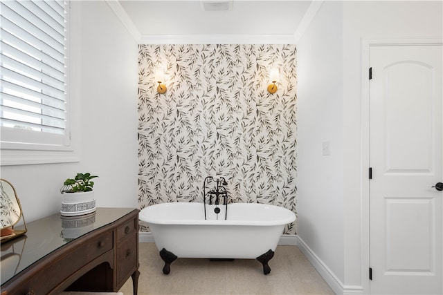 bathroom with crown molding, vanity, and a washtub