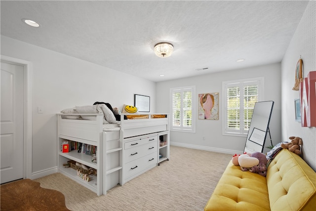 carpeted bedroom featuring a textured ceiling