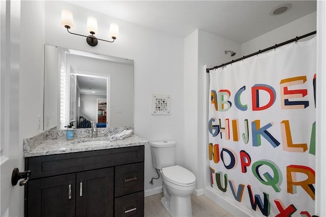 full bathroom with shower / tub combo, hardwood / wood-style floors, vanity, and toilet