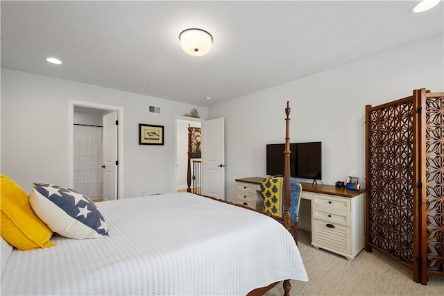 carpeted bedroom featuring ensuite bathroom