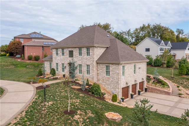 view of front facade featuring a garage and a front yard