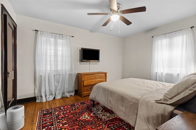 bedroom with wood-type flooring and ceiling fan