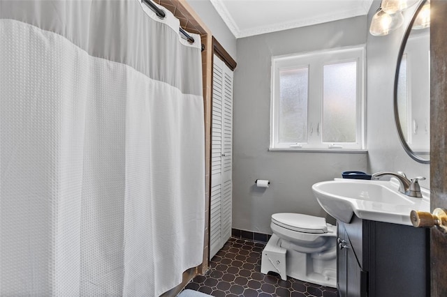 bathroom with crown molding, vanity, and toilet