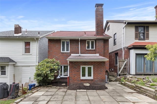 rear view of property featuring a patio area