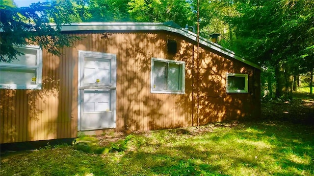 view of outbuilding featuring a lawn