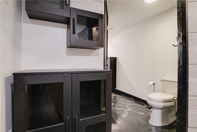 bathroom featuring vanity, toilet, and concrete floors