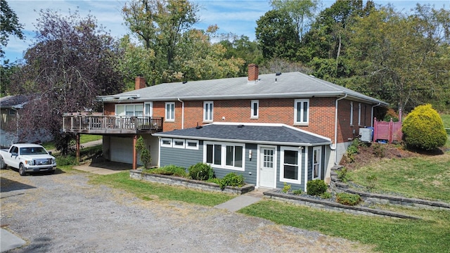 view of front of property featuring a garage and central AC