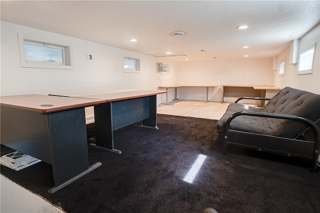 home office featuring carpet floors and a textured ceiling