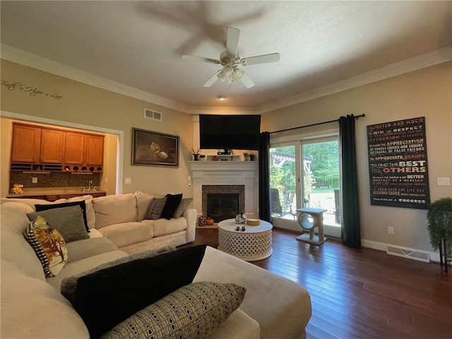 living room featuring ornamental molding, ceiling fan, dark hardwood / wood-style floors, and sink