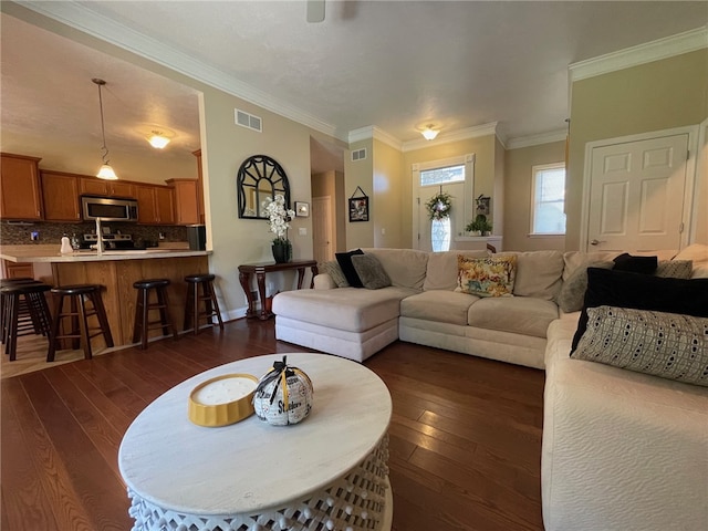 living room with crown molding and dark hardwood / wood-style floors