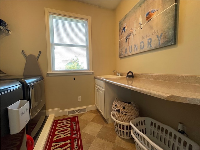 laundry room with washer and clothes dryer, cabinets, and sink