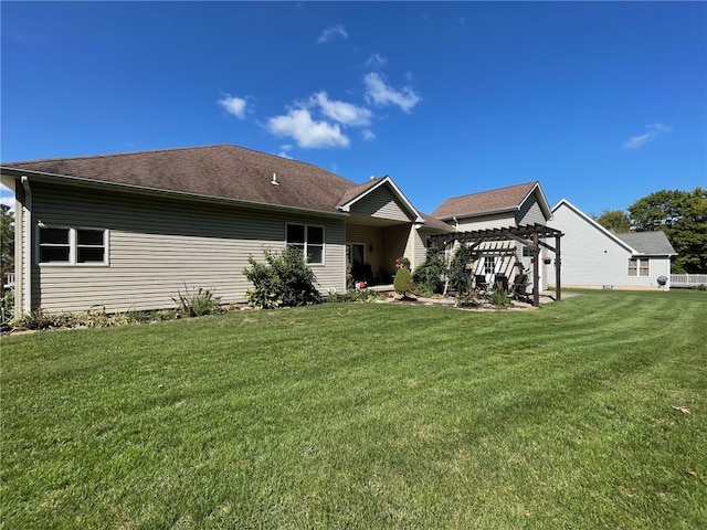 rear view of property with a pergola and a yard