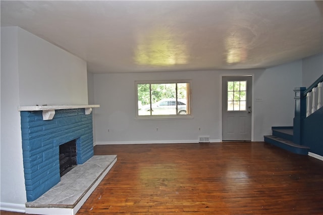 unfurnished living room featuring dark wood-type flooring