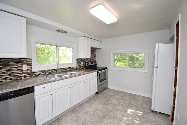 kitchen featuring white cabinetry, a wealth of natural light, stainless steel appliances, and sink