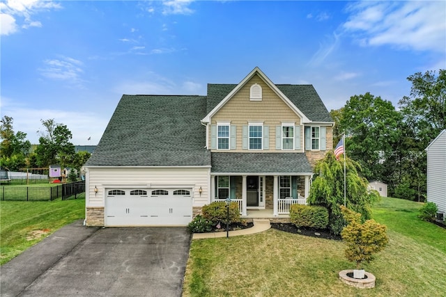 view of front of home with a front lawn, a garage, and covered porch