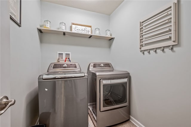 clothes washing area with washer and clothes dryer