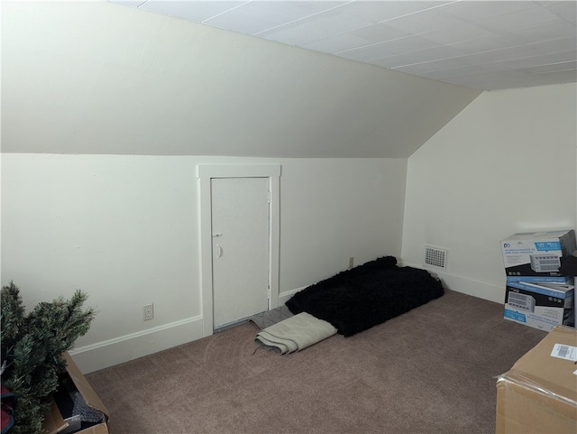 bonus room featuring vaulted ceiling and dark colored carpet