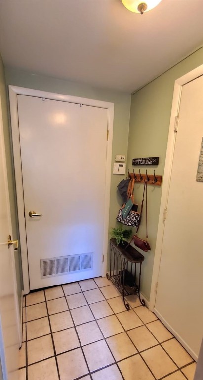 entryway with light tile patterned floors