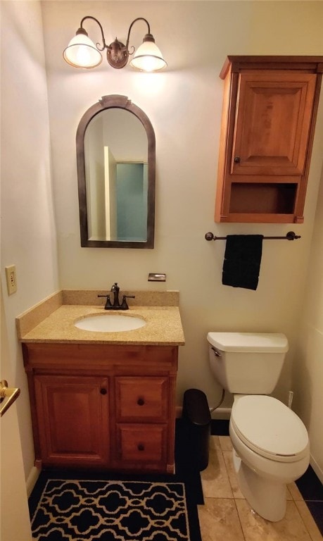 bathroom with vanity, tile patterned flooring, and toilet