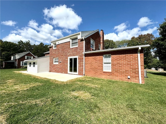 rear view of property with a patio area and a lawn