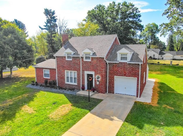 view of front of property with a front yard and a garage