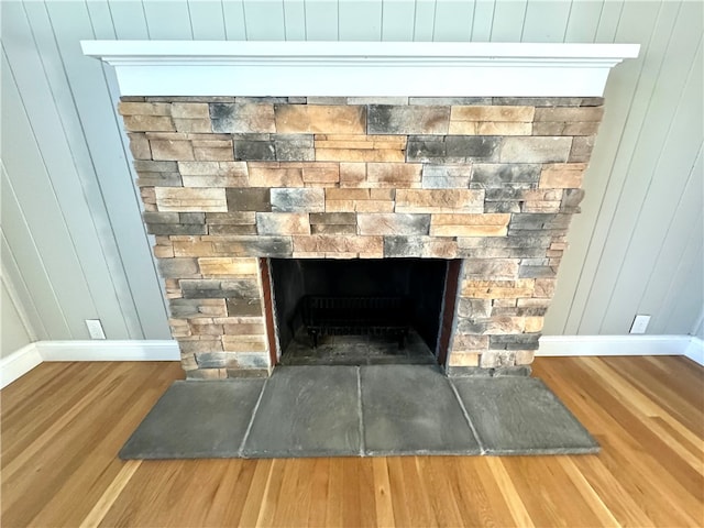 room details featuring wood walls and hardwood / wood-style floors