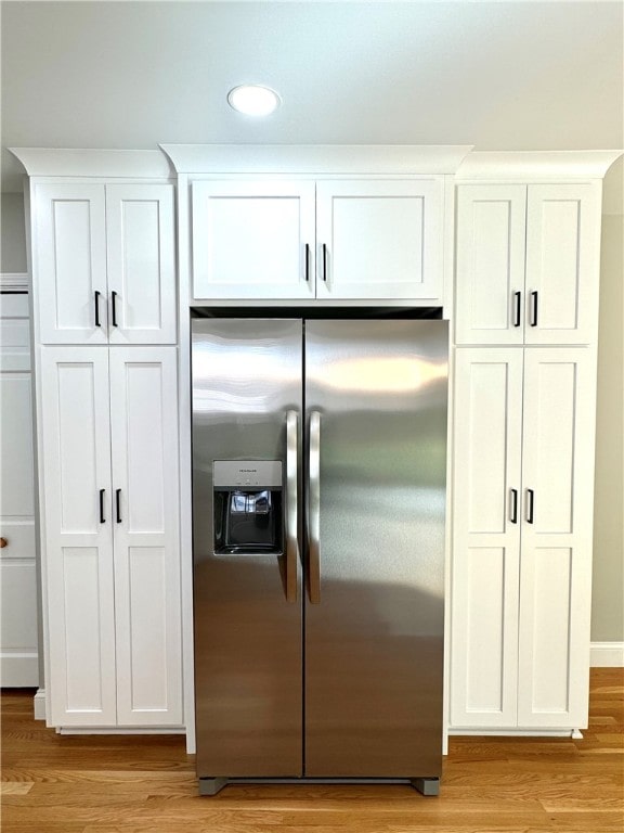 kitchen with white cabinetry, light hardwood / wood-style floors, and stainless steel refrigerator with ice dispenser