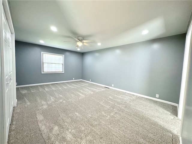 spare room with carpet flooring and ceiling fan