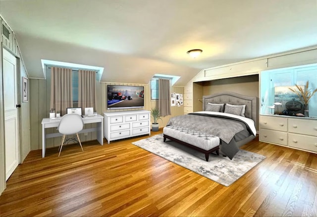 bedroom featuring lofted ceiling and light wood-type flooring