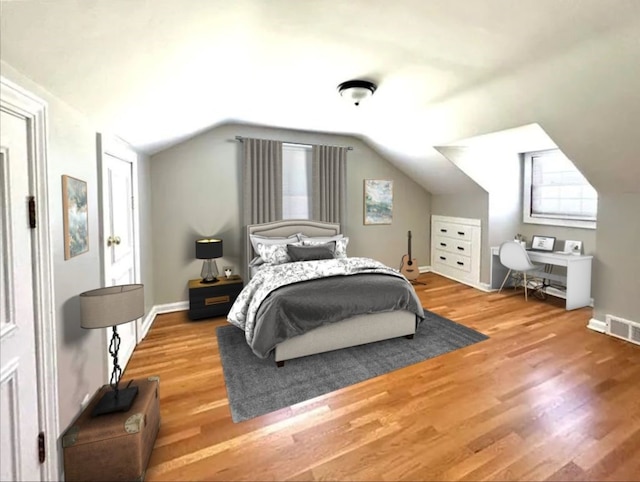 bedroom with lofted ceiling and hardwood / wood-style flooring